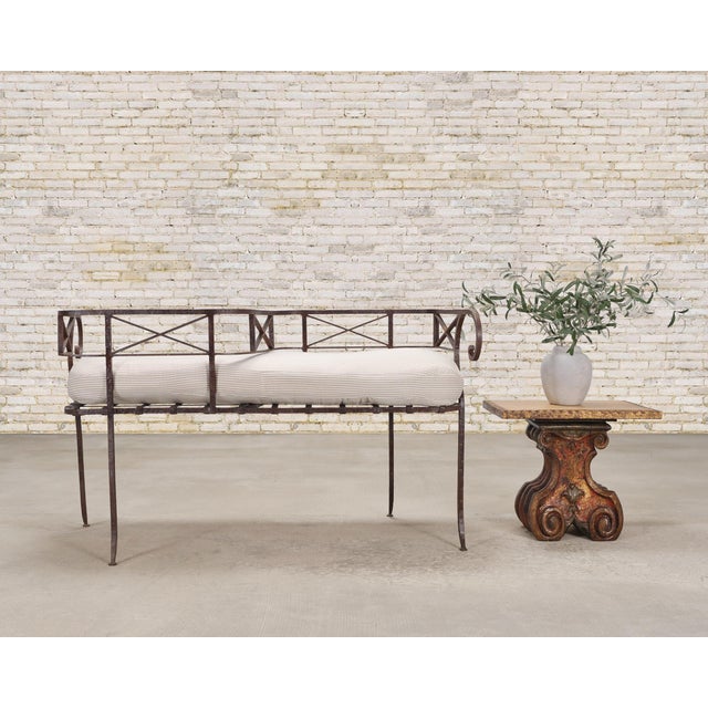 A beautifully crafted 20th century wrought iron tête-à-tête banquette garden bench crafted in a dramatic French...