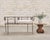 A beautifully crafted 20th century wrought iron tête-à-tête banquette garden bench crafted in a dramatic French...
