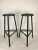 Set of two black metal 1960s Italian industrial design three-legged bar high stools with comfortable foot rail. Measures:...
