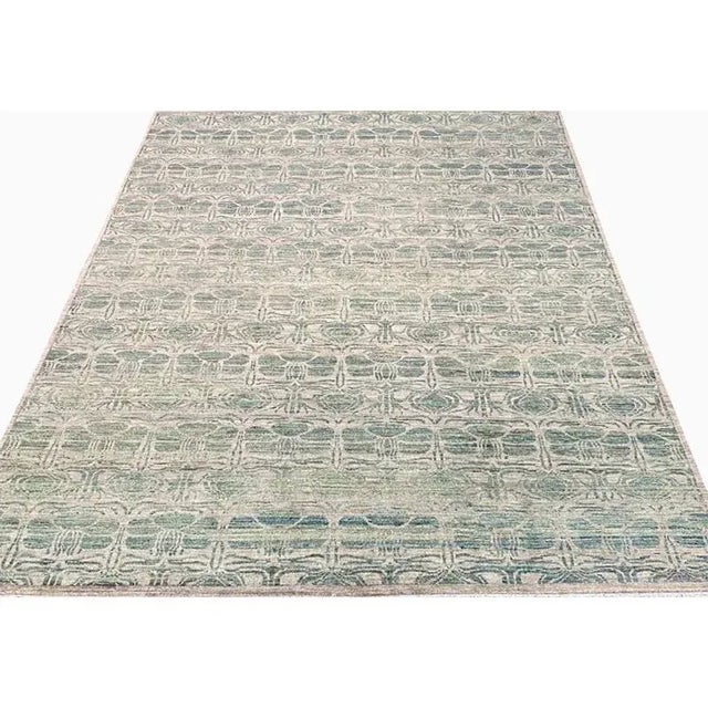 ACTUAL SIZE: 9’3″ x 11’10” PRIMARY COLOR: Taupe / Green AGE: New ORIGIN: Pakistan MATERIALS: Wool FOUNDATION: Cotton...