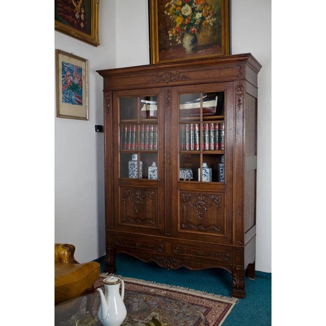 Representative two-wing antique bookcase - showcase made of solid oak wood, made around 1900 in the style of Rococo...