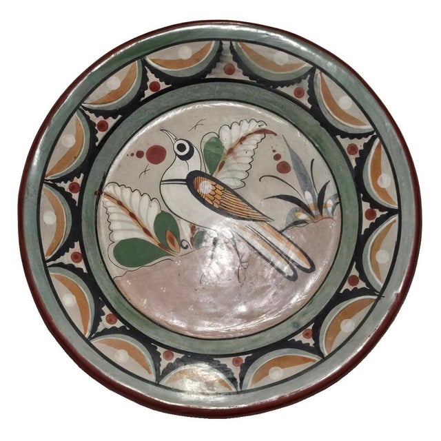 Offered is a vintage mid 20th Century decorative plate made in Tonalá, Jalisco, Mexico, a province renowned for its earth-...