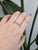 A modern take on a classic symbol, this women's wedding band is crafted in solid 14k yellow gold with flush-set natural...