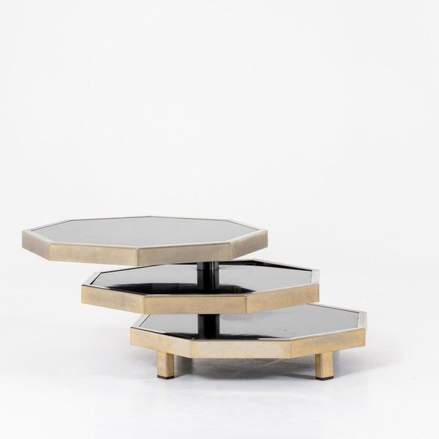 Modernist octagonal coffee table attributed to Acerbis in steel and black laminate with three adjustable levels.