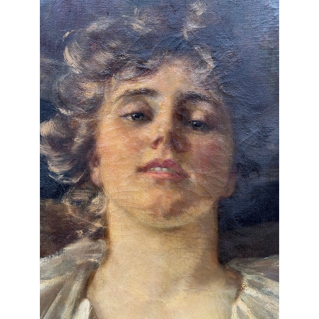 Just an incredible antique oil on canvas. It’s an unusual, intimate portrait of a glance between lovers. The collar of her...