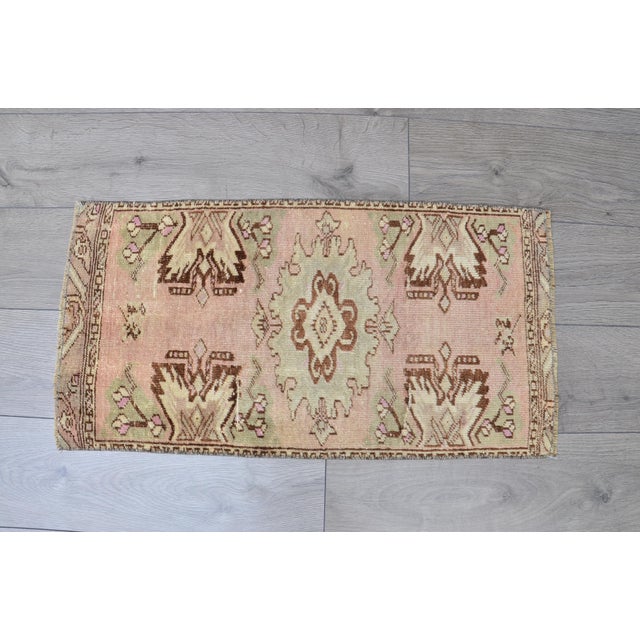 This is a vintage Turkish Oushak rug from the 1960s. The piece was hand-knotted.