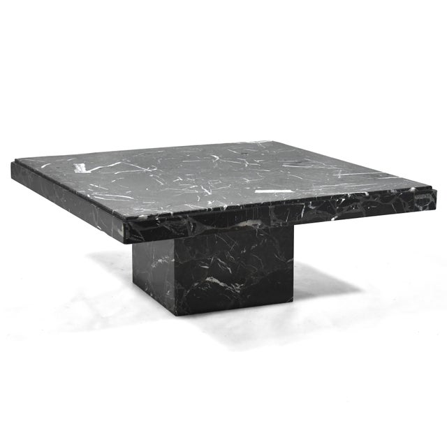 An elegant, minimalist form, this side table by Ello is crafted of black composite marble. Also available is the matching...