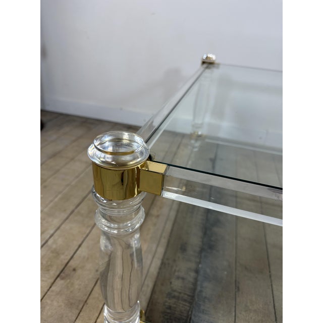 Large square Hollywood Regency coffee table in acrylic glass with two glass shelves in the style of Romeo, France, 1970....