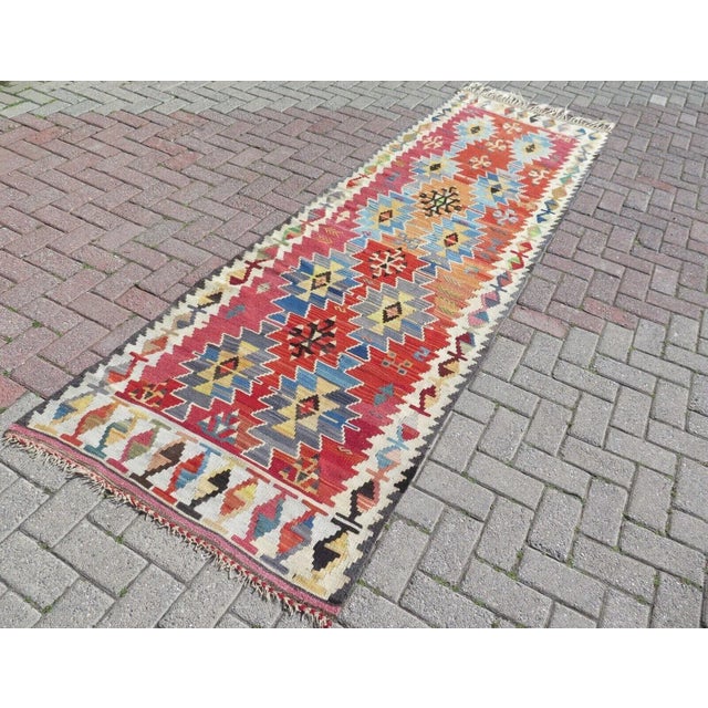 This beautiful, traditional vintage, flatweaved Turkish runner is approximately 60 years old. It is handmade of very fine...