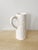 Modern white ceramic pitcher, with subtle indent design, made in Portugal. Could be used as vase, as decor. Dimensions: 9"...