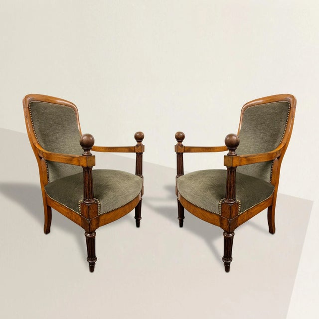 A striking and steadfast pair of early 19th century English Regency period armchairs with perfectly curved backs, columnar...