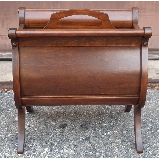 An early 20th Century magazine rack in a lyre shape by Ferguson Bros Manufacturing Co.. Freshly and professionally...