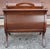An early 20th Century magazine rack in a lyre shape by Ferguson Bros Manufacturing Co.. Freshly and professionally...