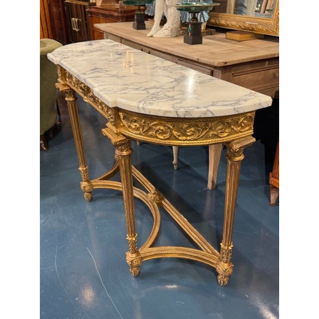 The 19th Century French Carved and Giltwood Console with Marble Top exudes traditional elegance and charm. The intricate...