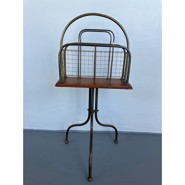 This is a really delightful revolving book or magazine stand in brass with oak wood platform. It is likely of English...