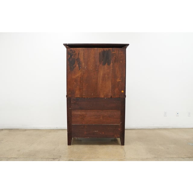 Vintage butler’s secretary desk on chest featuring beautifully figured wood grain, classic brass hardware, and a warm,...