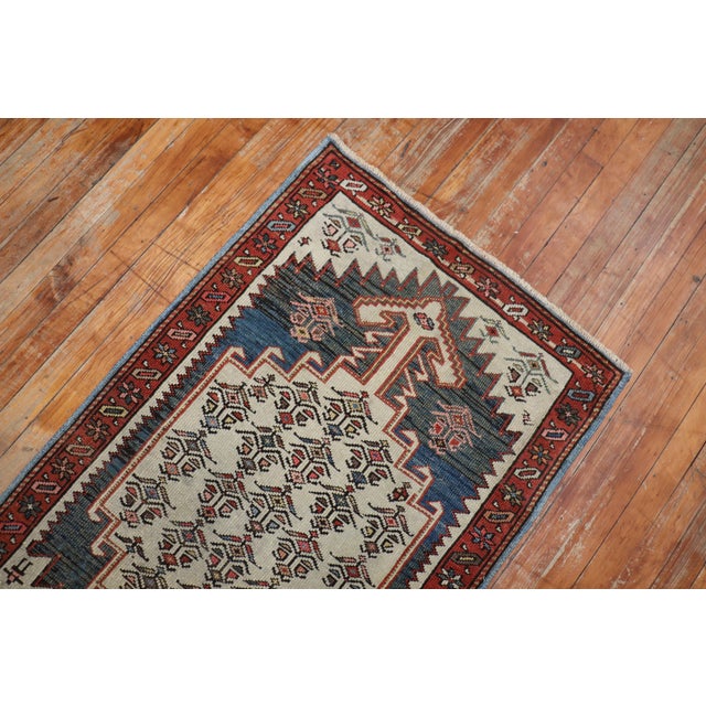 An early 20th century Narrow Tribal Northwest Persian Runner Measures: 2'6" x 12'1".