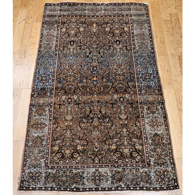 "A late 19th century Persian Farahan area rug, hand-knotted in camel hair with an elegant allover botanical design. The...