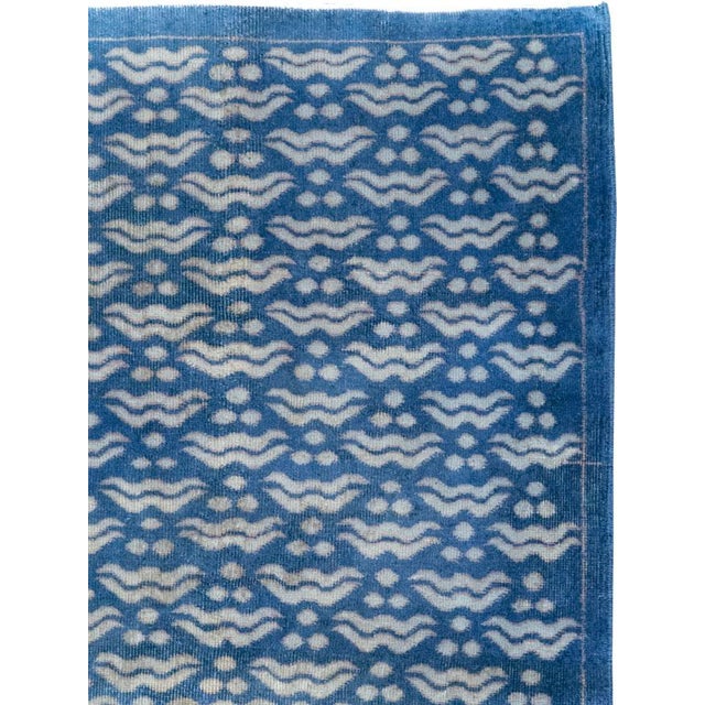 This Mid-20th century Turkish Anatolian small room-size carpet presents a crisp allover pattern rendered in a cool palette...