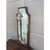 A distinctive Italian capriccio landscape, painted in oil on a shaped panel and presented in a softly worn giltwood frame....