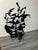 A wonderful abstract art sculpture resembling a flock of birds made entirely from cut and assembled black painted metal by...