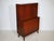 Mid-century teak bar cabinet, 1960s. Compact cabinet with a vertically divided front, a bar top, and slender tapered legs....