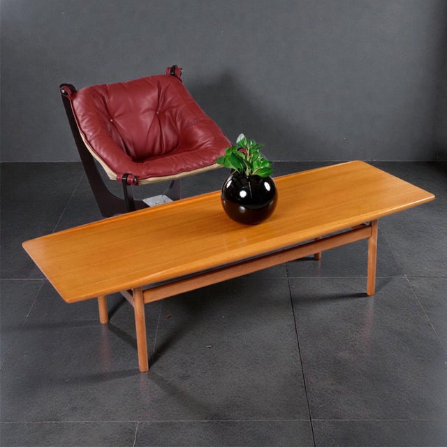 We are pleased to present this super rare Ole Wanscher Danish teak surfboard coffee table. Designed by Wanscher for Poul...