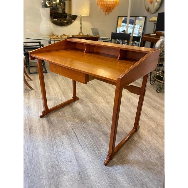A desk made of teak wood with a Swedish-style design. The desk was made in the 1950s and displays characteristics typical...