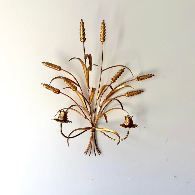 Mid-century modern gold tole wheat large candlestick holder sconce. The piece is in brushed gold and gold leaf type, a...