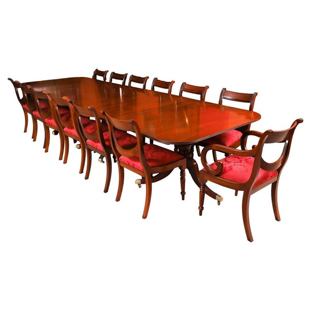 This is an elegant dining set that comprises an antique Regency Revival triple pillar dining table, by the renowned...
