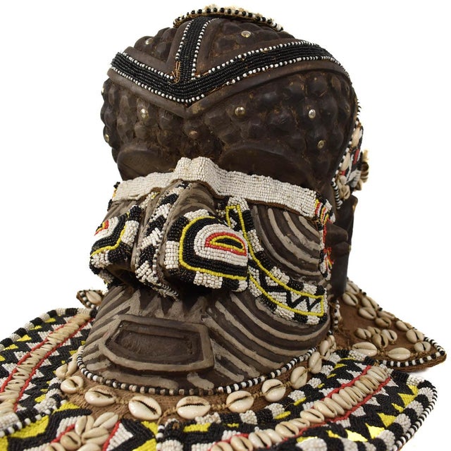 Embrace the striking beauty and cultural significance of the Kuba Mask Bwoom Royal Helmet from Congo. Adorned with...