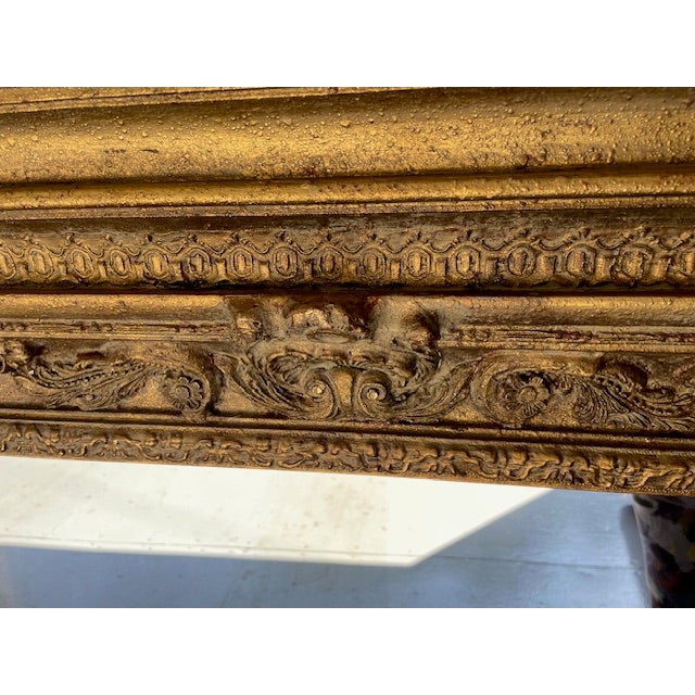 The mirror's gilded carving make it a statement piece suitable for both classic and contemporary interiors. It would be at...