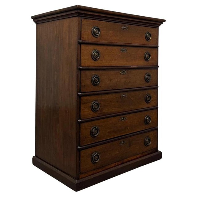 A handsome and well-crafted early 20th-century English Edwardian chest of drawers, designed in the Georgian style and...