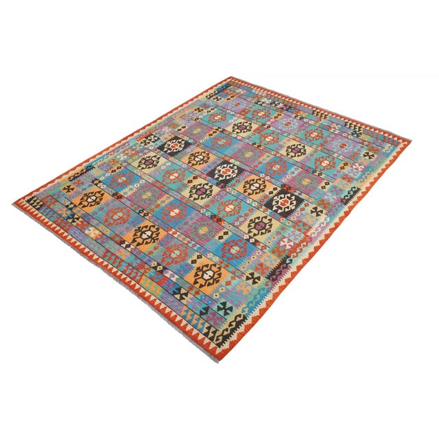 Add a touch of elegance to your home with this casual chic hand woven Tribal Kilim wool rug. Constructed on a loom by...