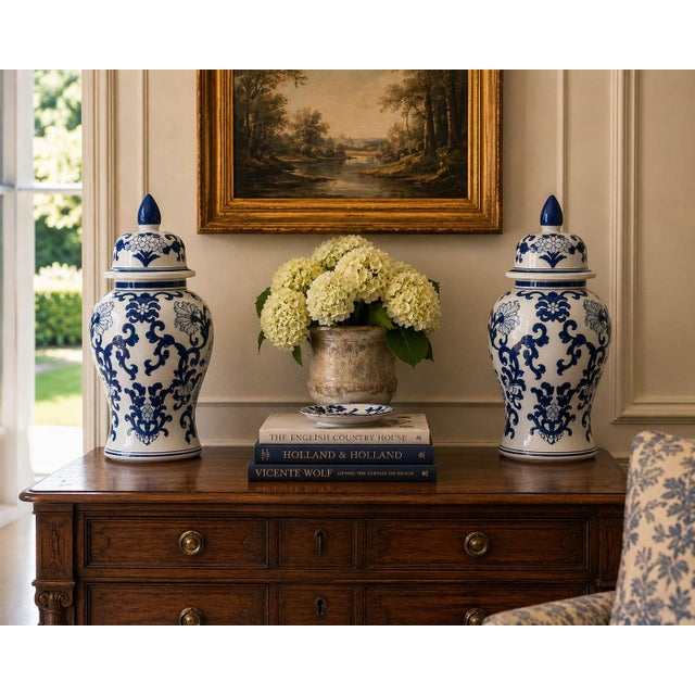 A classic pair of blue and white ginger jars, decorated throughout with delicate Chinese floral motifs. The pattern is...