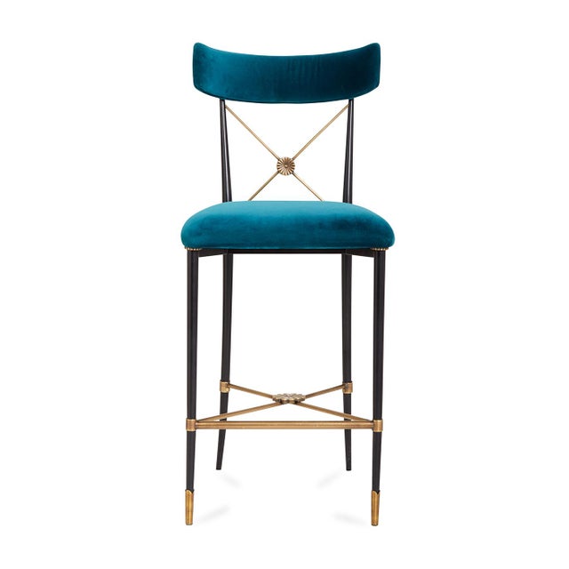 Our modern homage to an Empire-style dining chair, now perfect for your kitchen counter. Our Rider Counter Stool balances...