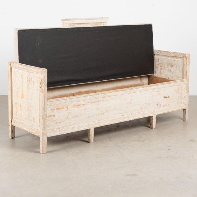 19th century Swedish Gustavian bench, crafted in pine with a beautifully aged antique white painted finish and faint gray...