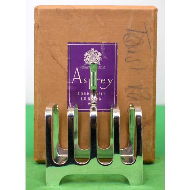 Box Sz: 6 1/2"H x 5"W x 4 3/4"D Toast rack Sz: 4 1/2"H x 3 1/4"W x 2 1/2"D Engraved: Made in England/ Hard Soldered/ D52
