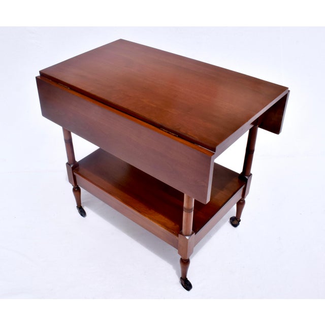 Solid Cherry two tier drop leaf tea trolly / bar cart with two dovetail drawers on casters by John Stewart. A very sweet,...