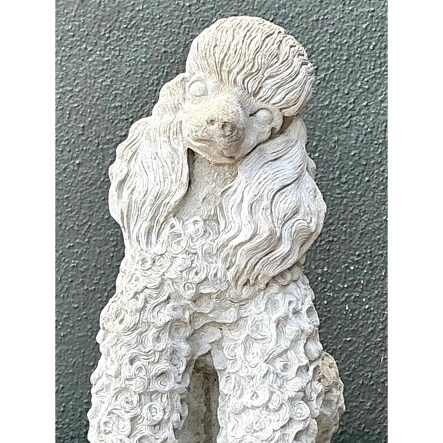 Sculpted with endearing charm and classical detail, this mid-20th-century garden statue captures the poise of a seated...