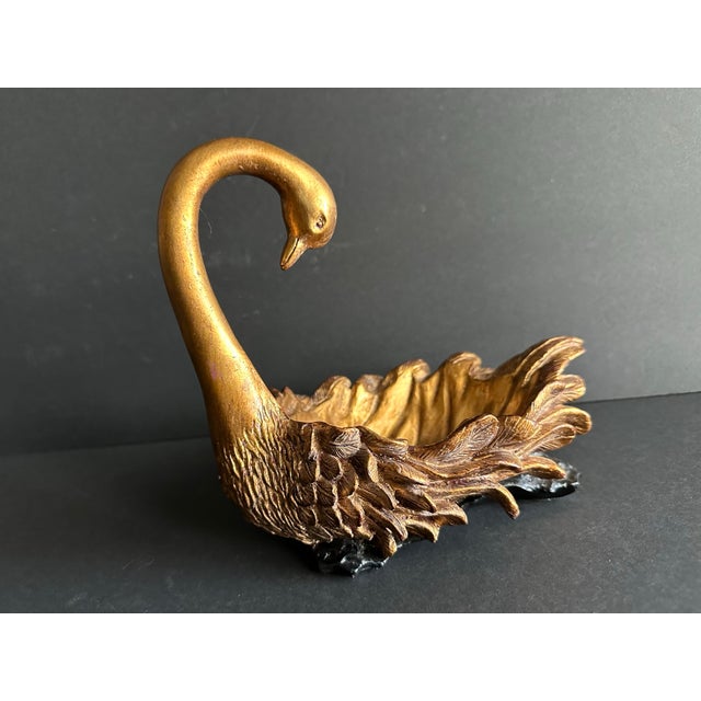 Heavy resin swan shaped decorative bowl. Gold with black feet. 10” x 6” x 8”. Weighs 3 pounds, 3.4 ounces.