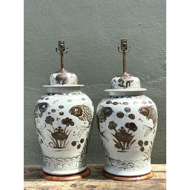 Elevate your interior with this striking pair of monumental glazed ceramic table lamps, featuring a captivating hand-...