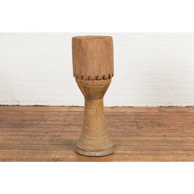 A tall antique Thai freestanding ceremonial wooden drum from the early 20th century, with natural finish, carved accents...