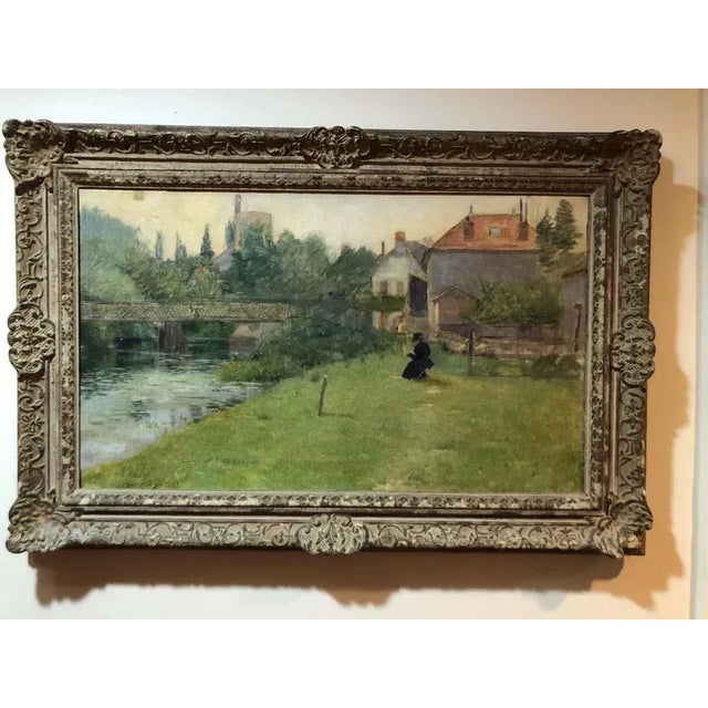 Frank Vincent DuMond painting. Bucolic setting of a woman in a pastoral scene by a river. She is seated reading and...