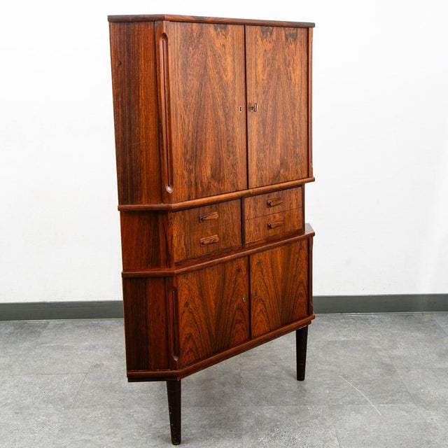 Outstanding Danish rosewood corner cabinet on tapered legs designed in Denmark, circa 1960s. Features four central...
