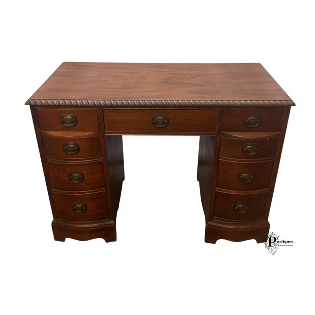 Vintage Georgian Style Desk featuring High Quality Mahogany Construction, Carved Trim, and Seven Dovetailed Drawers with...