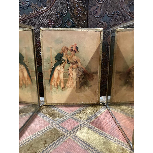 Antique Folding Triptych Mirror – Chiseled Brass & Courting Scene Panels, Late 19th Century A beautiful antique folding...
