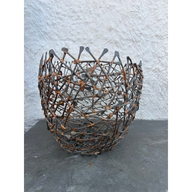 Stylized oval shaped birds nest made of soldered metal rods. The bowl is not marked.