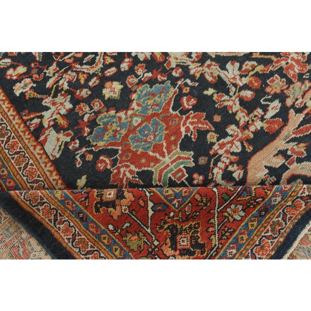 This antique Persian Sultanabad rug features multiple borders, an all-over botanical design, and its main border is made...