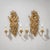 Pair of carved and giltwood wall lights in the form of fruit and floral bouquets, each fitted with two candle arms. For...